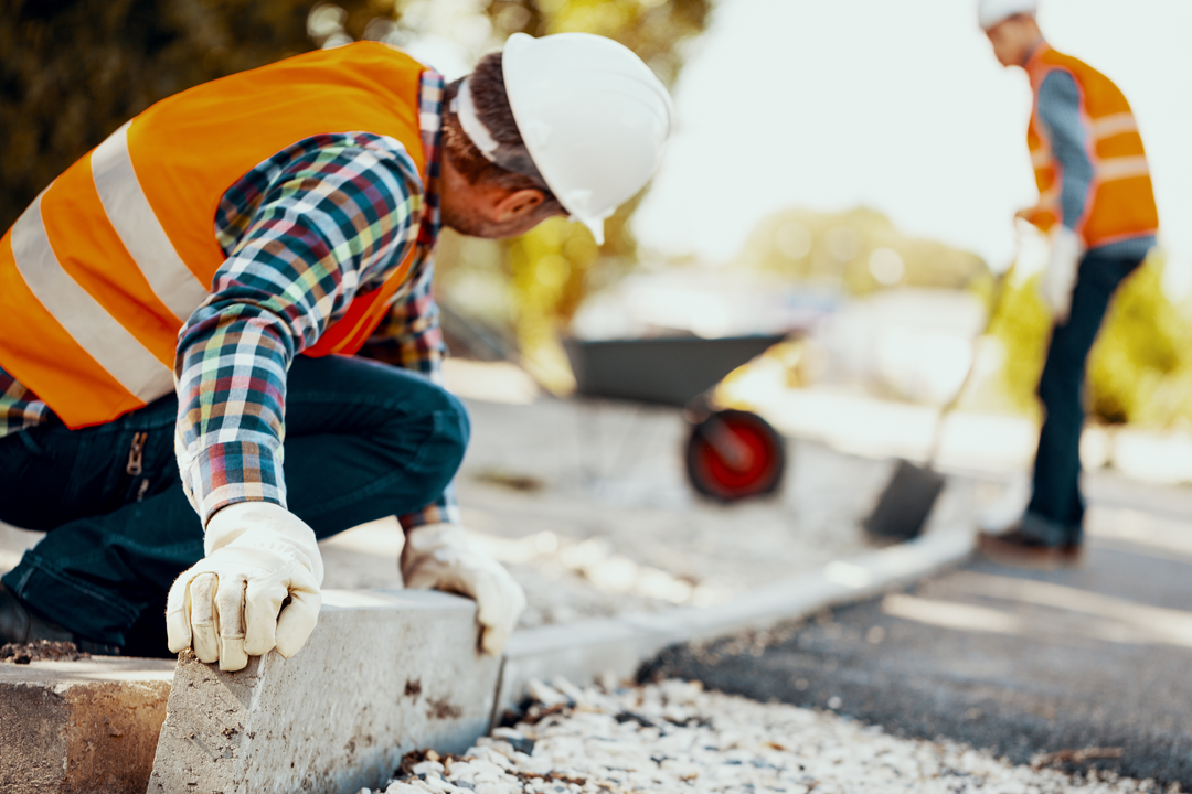 Contractor installing a dropped kerb - the type of works supported by a 1:100 scale plan