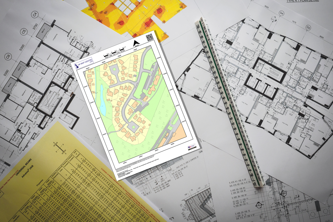 OS 1:1250 colour location plan on an architect desk with floor plans, ruler and hard hat - professional planning context