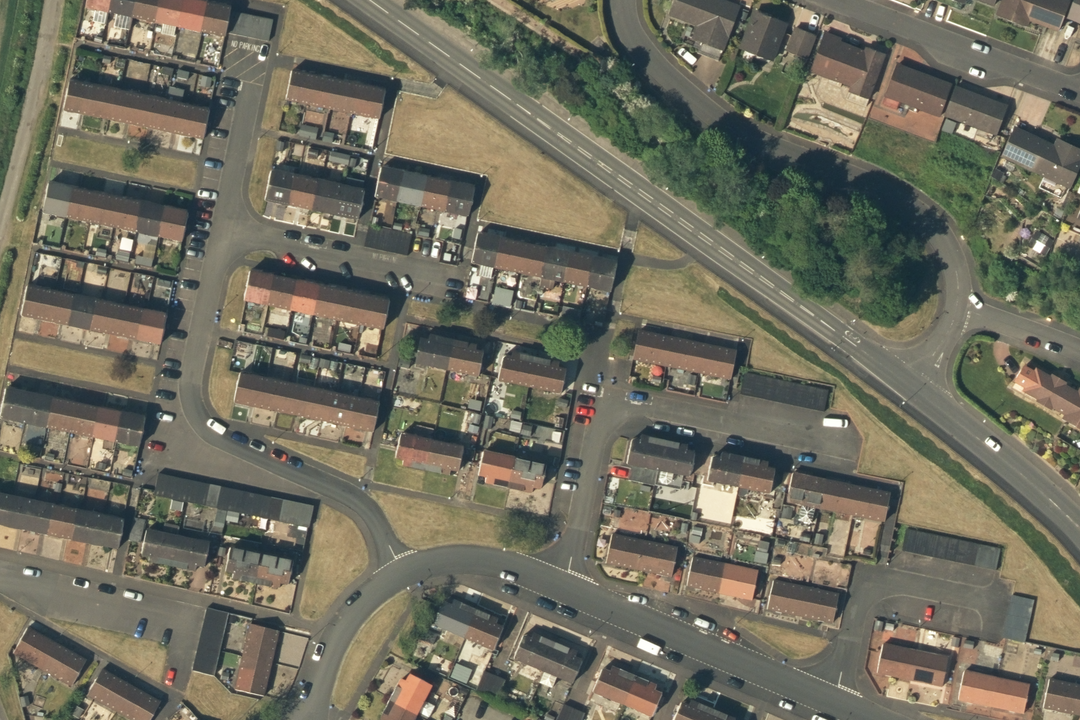 OS aerial imagery section showing a residential housing estate with terraced and semi-detached properties, gardens and access roads