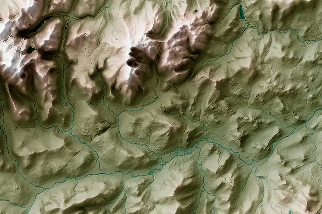 3D terrain surface render showing seamless tile joining across green and brown mountain valleys with river drainage and steep ridges